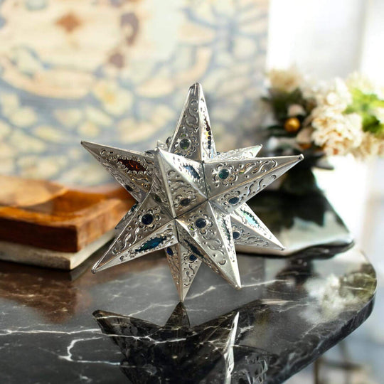 Handmade Metal Star Ornament | Stained Glass Light Fixture silver metal star with stained glass accents on marble table, handmade from Guanajuato, Mexico