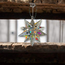 Handmade Metal Star Ornament | Stained Glass Light Fixture hanging in rustic wooden beam, colorful stained-glass points and lead-free hand-blown panes