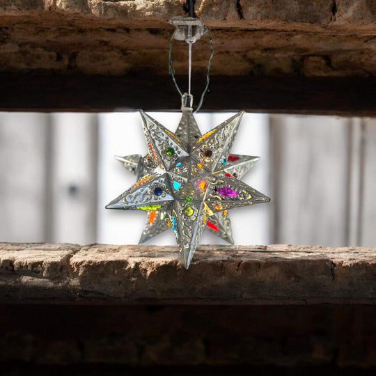 Handmade Metal Star Ornament | Stained Glass Light Fixture hanging in rustic wooden beam, colorful stained-glass points and lead-free hand-blown panes