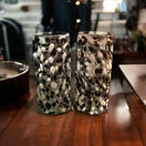 Handmade Mexican Double Shot Glass | Artisanal Black & White Confetti Design - pair of hand-blown confetti-patterned shot glasses on wooden table