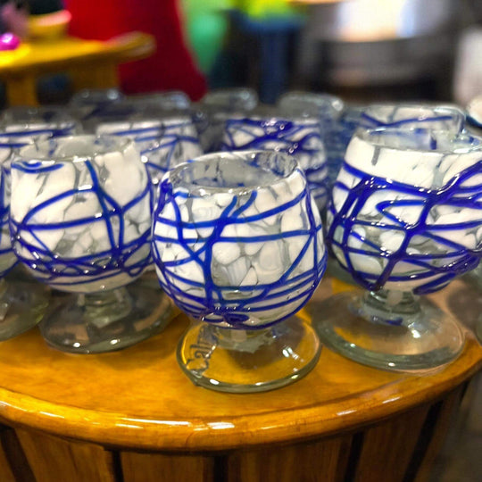 Mexican Artisan Shot Glass | Blue & White Cognac Style Design - handmade blue & white hand-blown glass shot glasses on wooden display