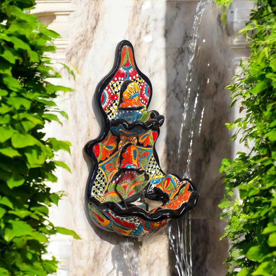 Handmade Mexican Talavera Wall Fountain | Authentic Art Decor (Large) hand-painted colorful three-tier wall fountain mounted on marble with green foliage