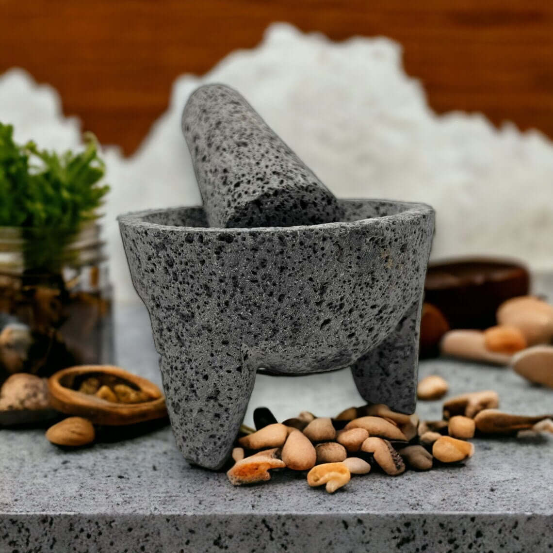 Mexican Volcanic Stone Molcajete | Handmade Mortar and Pestle on countertop with pestle and nuts, handcrafted in Guanajuato, Mexico