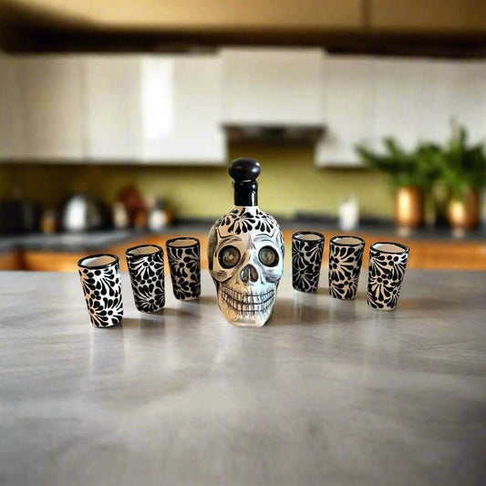 Handmade Skull Decanter Set | Black & White Mexican Barware — hand-blown skull decanter with six matching black and white shot glasses on kitchen counter