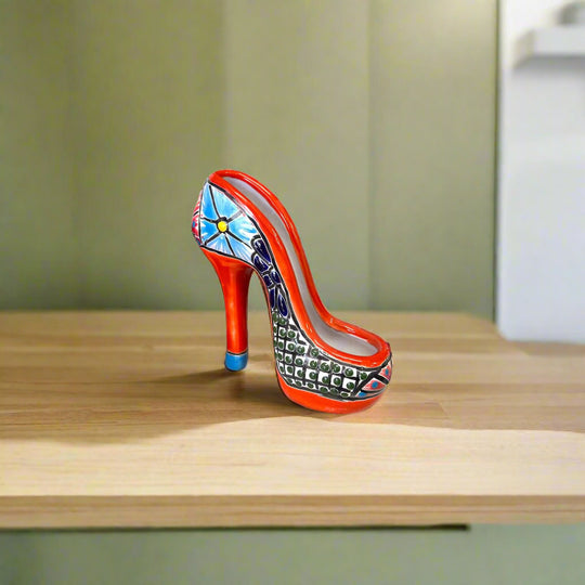 Talavera High Heel Statue | Colorful Handmade Mexican Decor - hand-painted Talavera ceramic high heel on wood shelf, vibrant red blue pattern