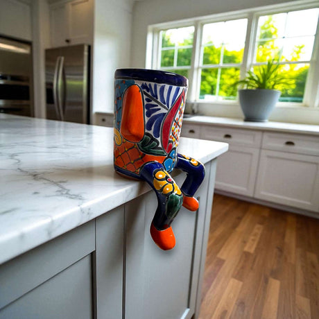 Talavera Person Planter | Table Edge Pot with Arms and Legs - hand-painted Mexican Talavera planter sitting on kitchen counter edge