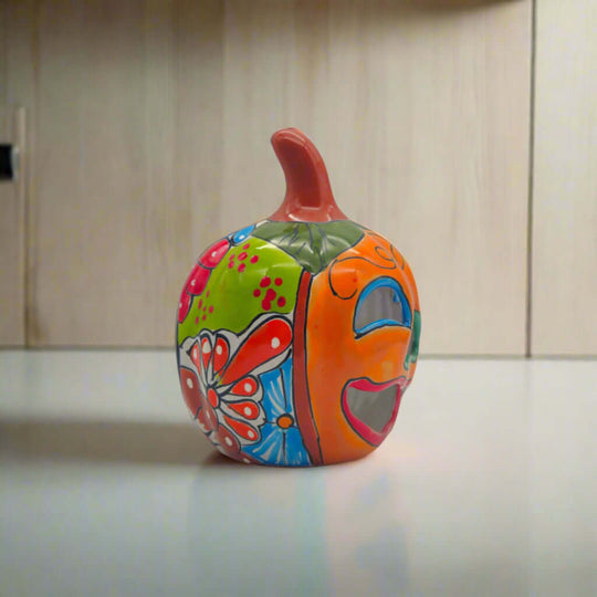 Handmade Talavera Pumpkin | Mexican Jack-O'-Lantern Decor with bright orange glaze, hand-painted green leaves and cheerful cut-out smile