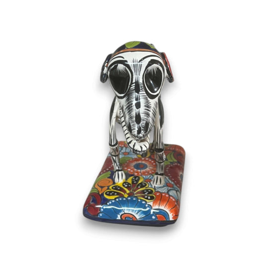 Colorful Talavera Skeleton Dog | Handmade Mexican Artistry — hand-painted Talavera skeletal dog statue on floral base