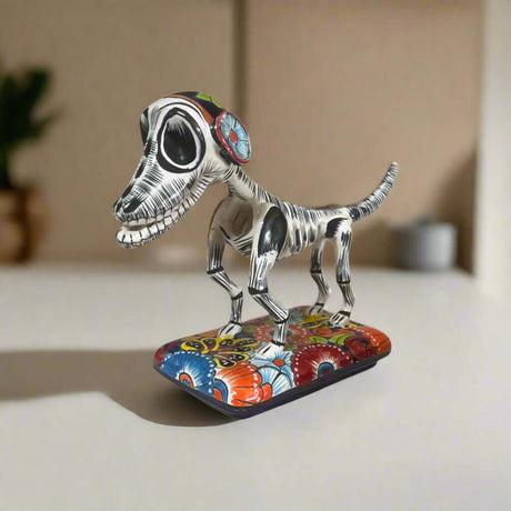 Colorful Talavera Skeleton Dog | Handmade Mexican Artistry - hand-painted Talavera skeleton dog statue on floral base, kiln-fired lead-free glaze