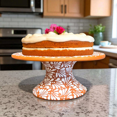 Talavera Cake Stand Set | Two-Piece Handmade Dessert Pedestal displaying hand-painted terracotta pedestal with white floral design holding frosted cake