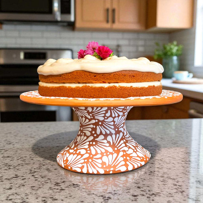 Talavera Cake Stand Set | Two-Piece Handmade Dessert Pedestal displaying hand-painted terracotta pedestal with white floral design holding frosted cake
