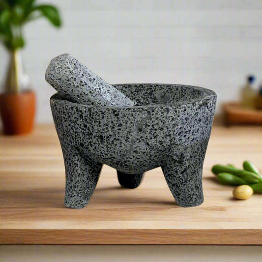 Volcanic Stone Molcajete | Handmade Mexican Mortar & Pestle hand-carved lava rock molcajete with tejolote on wooden counter, traditional Mexican kitchen