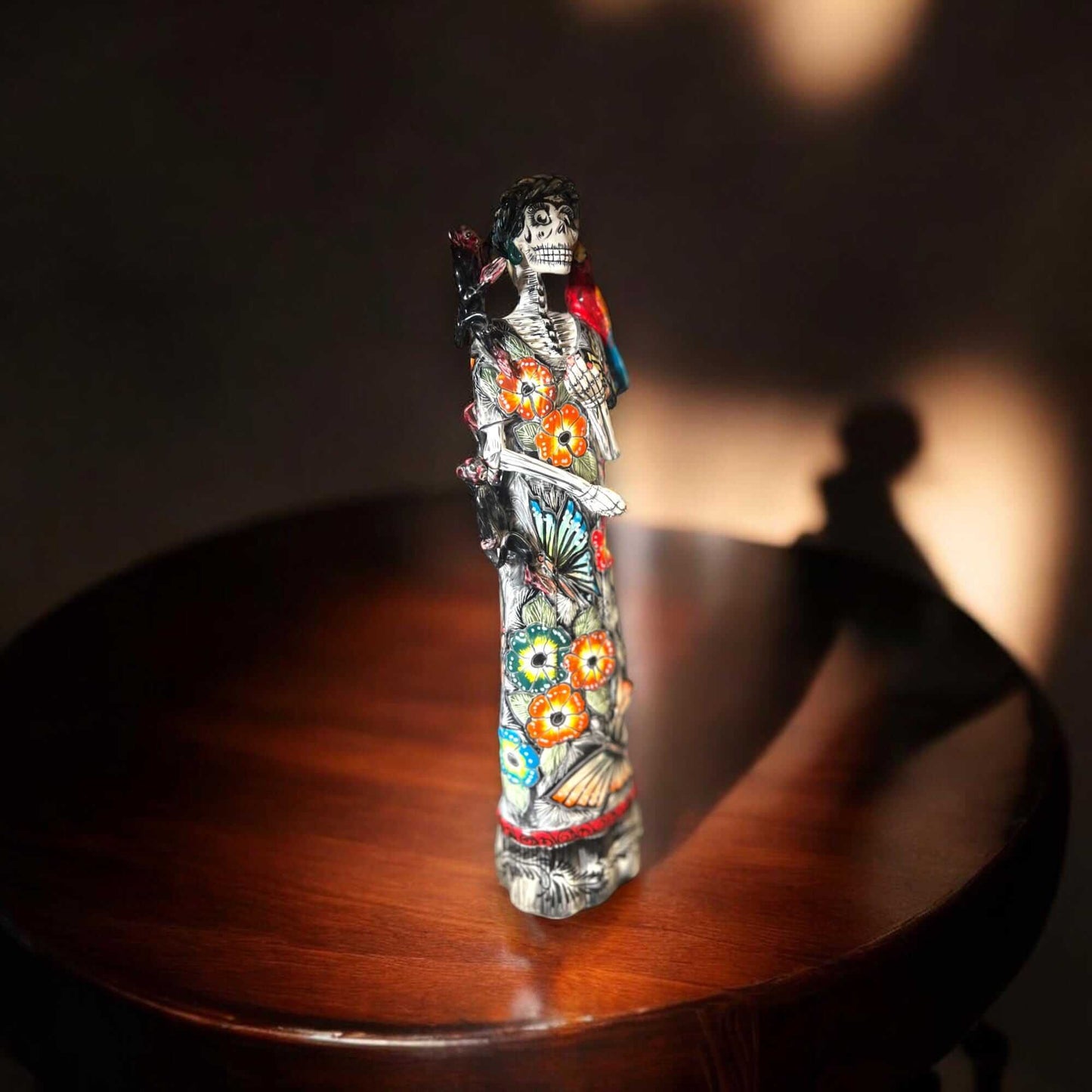 Talavera Catrina Figurine | Day of the Dead Skeleton with Monkey & Bird hand-painted Talavera Catrina in floral gown with parrots and butterflies