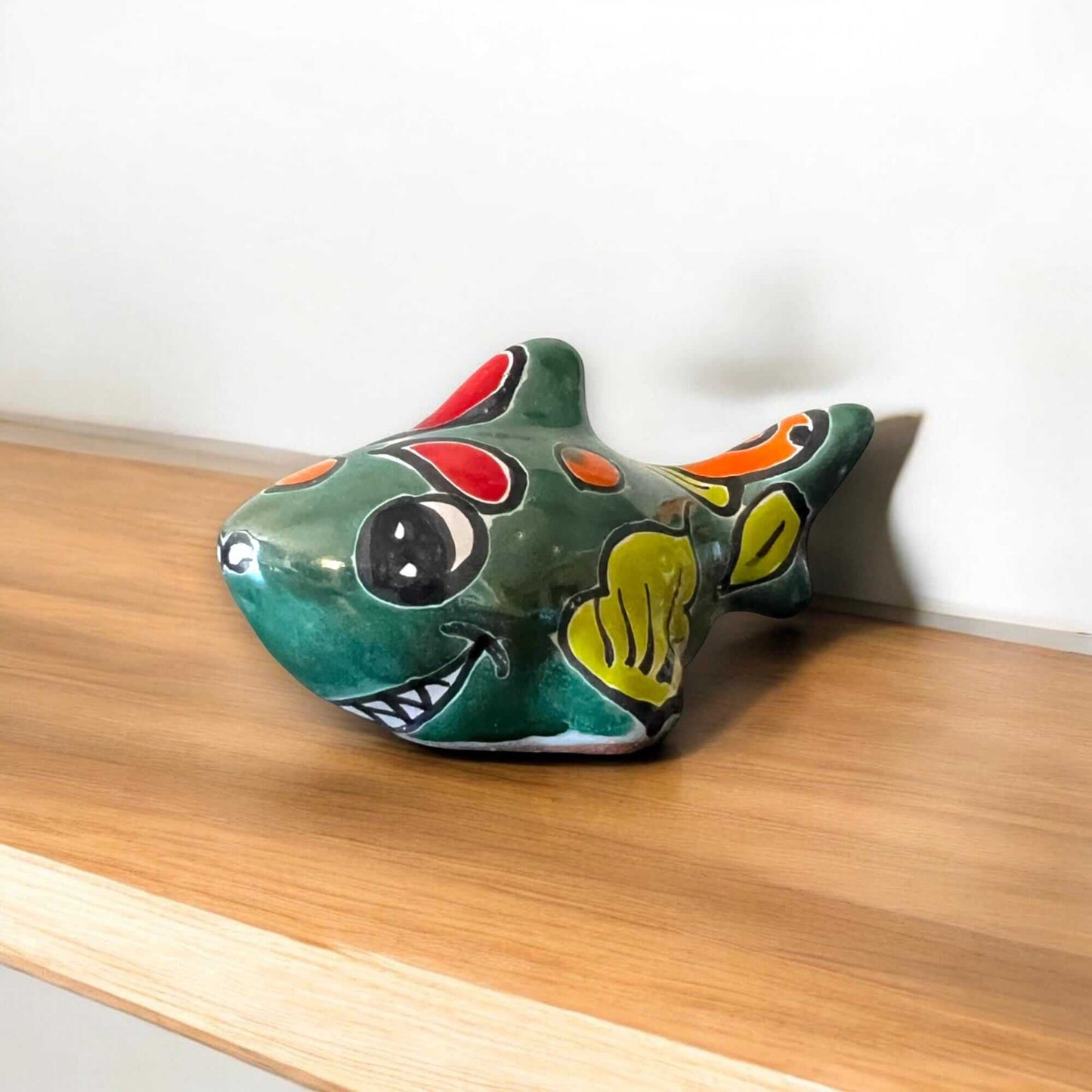 Colorful Talavera Shark Figurine | Handcrafted Mexican Pottery Decor - hand-painted green Talavera ceramic shark on wooden shelf