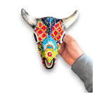 Talavera Bull Skull Wall Decor | Handmade Mexican Longhorn Art - hand-painted colorful Talavera ceramic longhorn skull held by hand