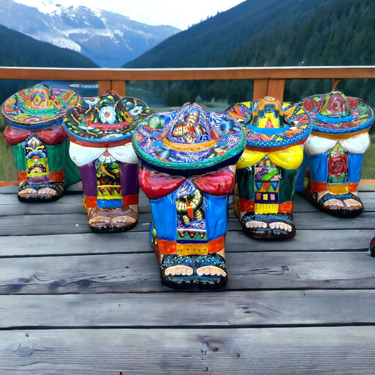 XL Talavera Panchito Statue | Hand-Painted Mexican Pottery Decor - colorful hand-painted ceramic Panchito stools displayed on a mountain-view deck
