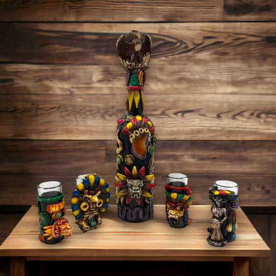 Aztec Warrior Tequila Set | Handmade Mexican Shot Glass & Decanter Set with sculpted colorful hand-painted decanter and four matching shot glasses on wooden table