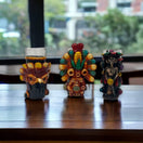 Handcrafted Mexican Shot Glass | Aztec Warrior Design - three colorful handcrafted Mexican shot glasses with Aztec warrior motifs on wooden table