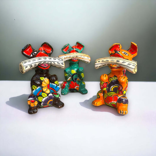 Talavera Dog Holding Newspaper Statue | Colorful Mexican Garden Art - three hand-painted red green orange Talavera dogs holding newspapers