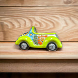 Colorful Hand-Painted Talavera Car Planter | Small Ceramic Car Statue - lime green hand-painted Talavera car planter on wooden shelf
