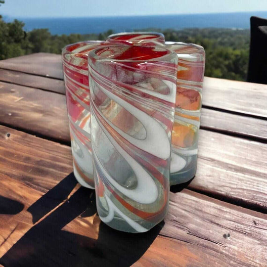 Festive Hand Blown Colorful Tumbler Glass | Red & White Candy Cane Design - hand-blown lead-free tumbler with swirled candy cane stripes on wooden table