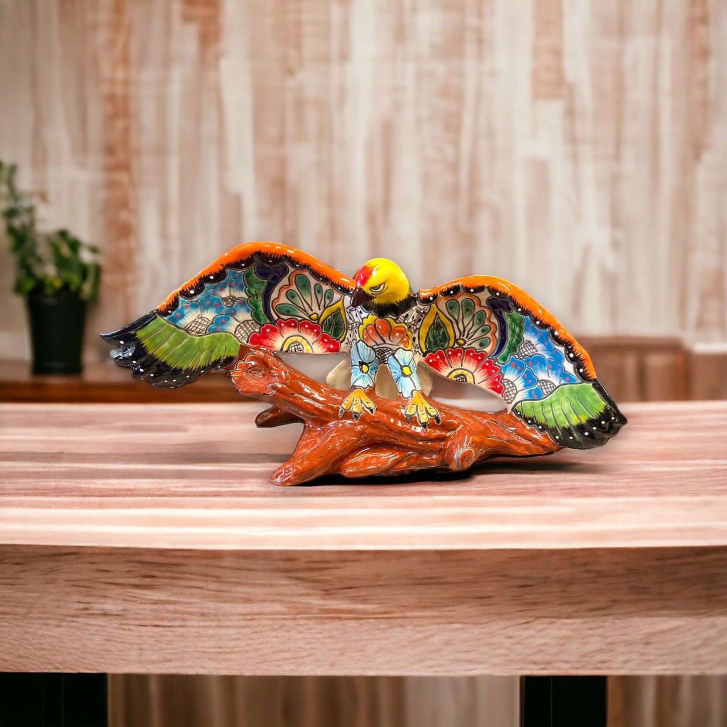 Majestic Talavera Eagle Figurine | Handcrafted Mexican Art - hand-painted cobalt, yellow and terracotta eagle on textured log base
