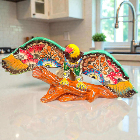 Majestic Talavera Eagle Figurine | Handcrafted Mexican Art hand-painted cobalt blue golden yellow terracotta eagle on textured log base