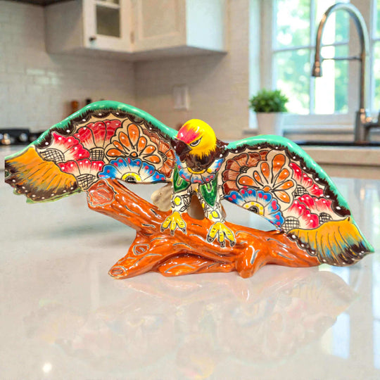 Majestic Talavera Eagle Figurine | Handcrafted Mexican Art hand-painted cobalt blue golden yellow terracotta eagle on textured log base