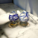 Mexican Artisan Shot Glass | Blue & White Cognac Style Design - handmade blue swirl lead-free glass shot glasses on marble (pair)