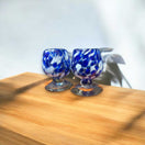 Mexican Artisan Shot Glass | Blue & White Cognac Style Design - hand-blown blue white glass shot glasses on wooden surface