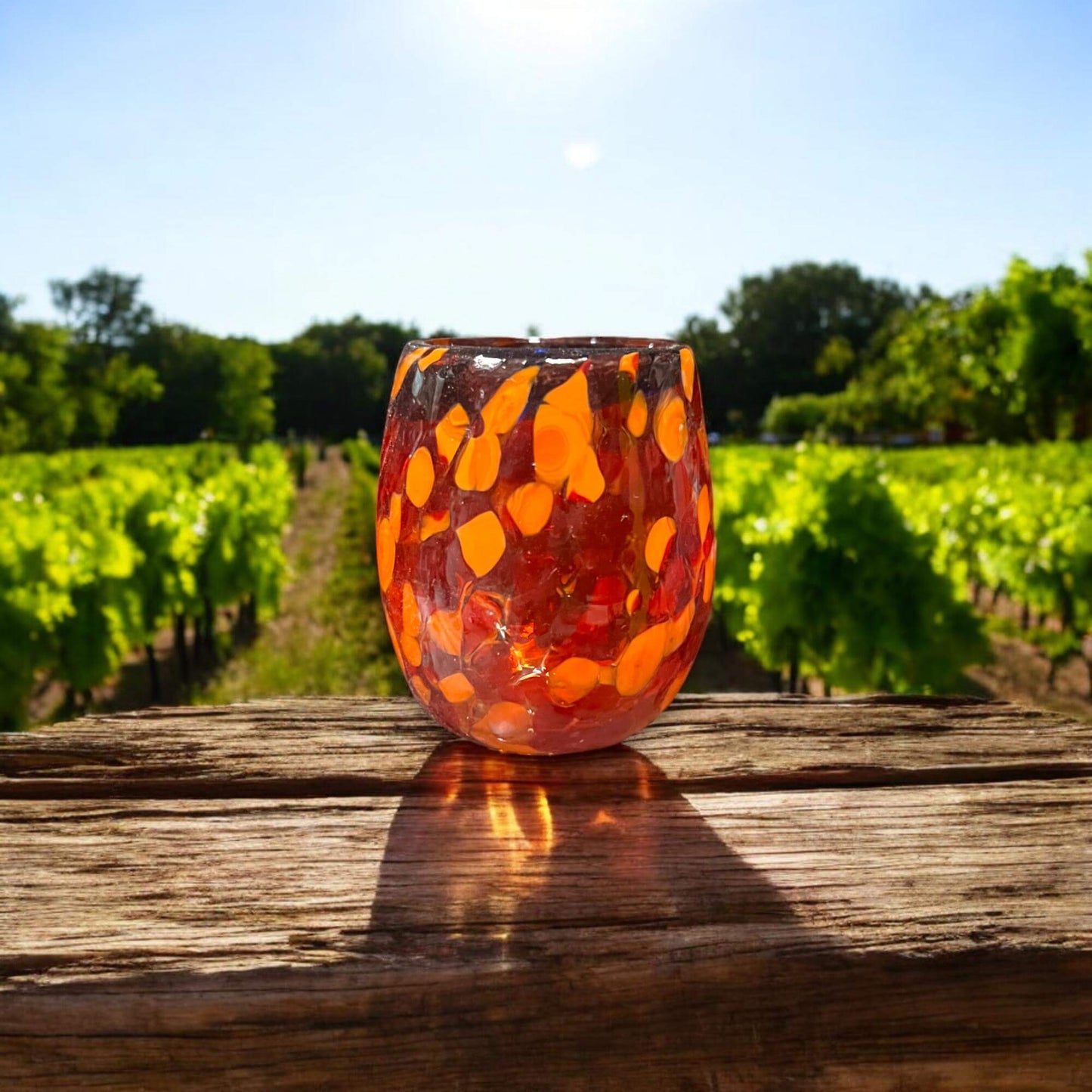 Mexican Artisan Shot Glass | Handmade Lava Design Ceramic hand-blown orange lava glass shot glass photographed outdoors