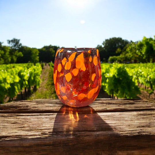 Mexican Artisan Shot Glass | Handmade Lava Design Ceramic hand-blown orange lava glass shot glass photographed outdoors