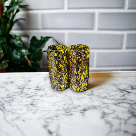 Mexican Artisan Double Shot Glass | Authentic Mocha & Yellow Design hand-blown double shot glass with yellow mocha swirl pattern on marble