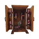 Front view of open wooden revolver decanter box with six decorated shot glasses