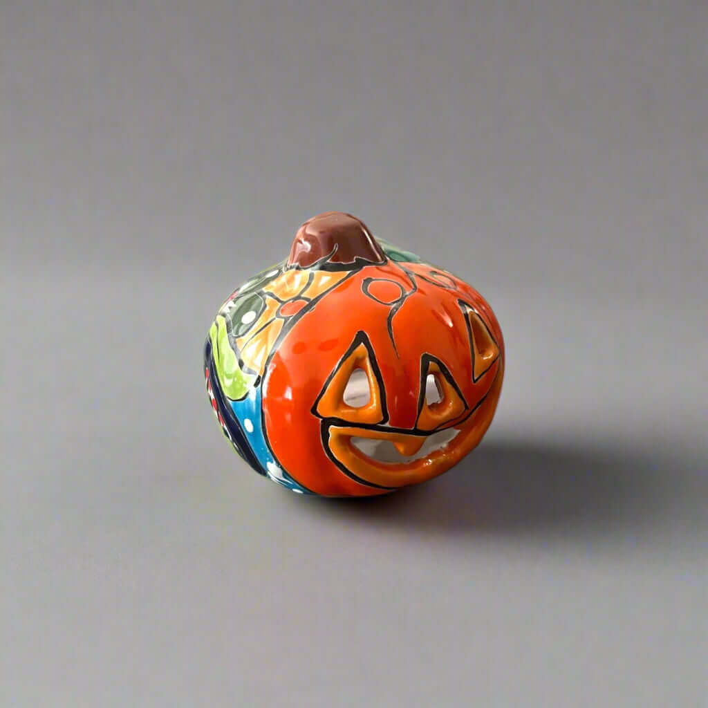 Mini Talavera Pumpkin | Handcrafted Mexican Jack-O'-Lantern - hand-painted orange ceramic pumpkin with carved jack-o'-lantern face and floral Talavera accents