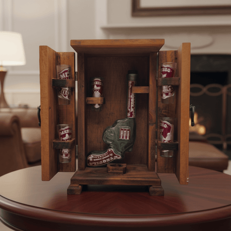 Open wooden Mexican decanter box showing revolver decanter and six shot glasses