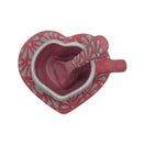 Top view of pink heart mug, floral plate, and matching patterned spoon