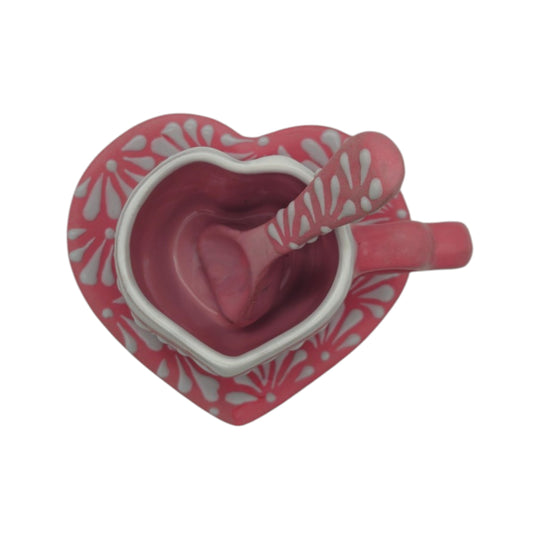 Top view of pink heart mug, floral plate, and matching patterned spoon