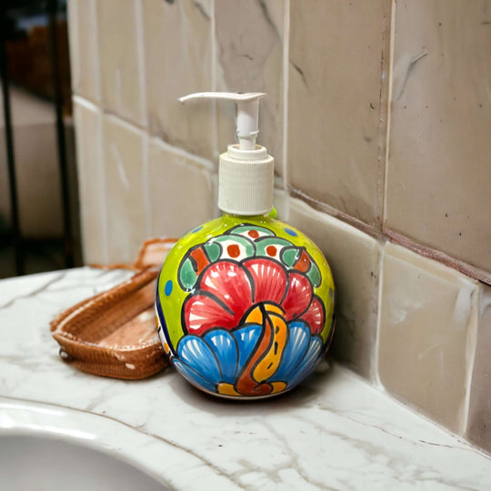 Round Talavera Soap Dispenser | Hand-Painted Ceramic Bottle on marble sink with colorful hand-painted floral motifs and clear pump