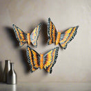 Set of 3 Talavera Butterfly Wall Hangings | Handmade Ceramic Decor - vibrant hand-painted orange Talavera ceramic butterflies on neutral wall