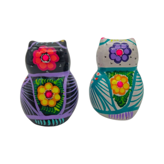 Pair of owl salt and pepper shakers with floral patterns photographed on white