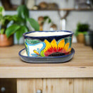 Small Talavera Flower Pot | Colorful Hand-Painted Mexican Planter on wooden shelf with sunflower design and matching saucer, handcrafted in Guanajuato