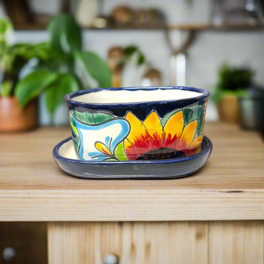 Small Talavera Flower Pot | Colorful Hand-Painted Mexican Planter on wooden shelf with sunflower design and matching saucer, handcrafted in Guanajuato