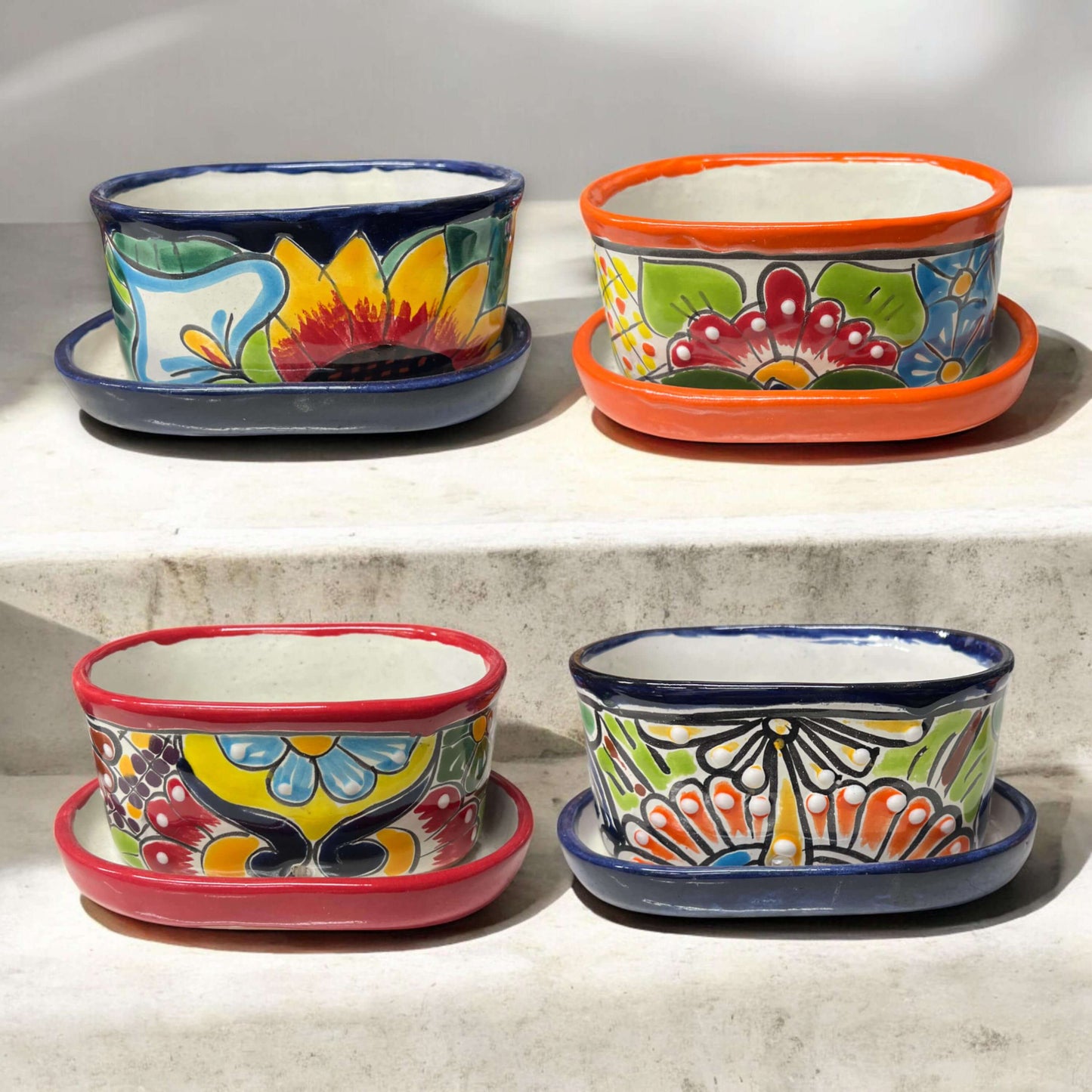 Small Talavera Flower Pot | Colorful Hand-Painted Mexican Planter showing four vibrant hand-painted Talavera planters with saucers
