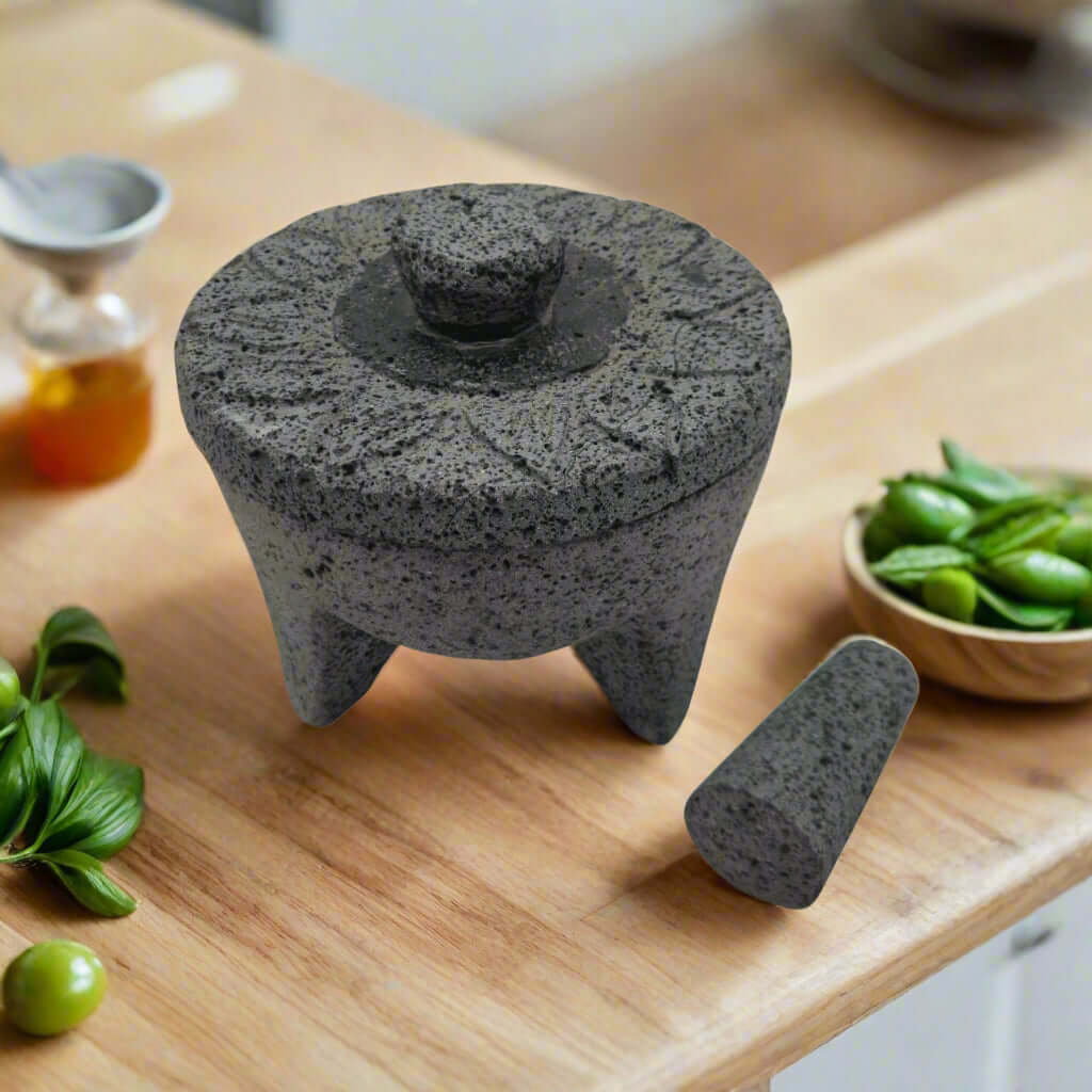 Sunflower Lid Volcanic Molcajete | Mexican Mortar & Pestle - hand-carved volcanic stone molcajete with sunflower lid on wooden board
