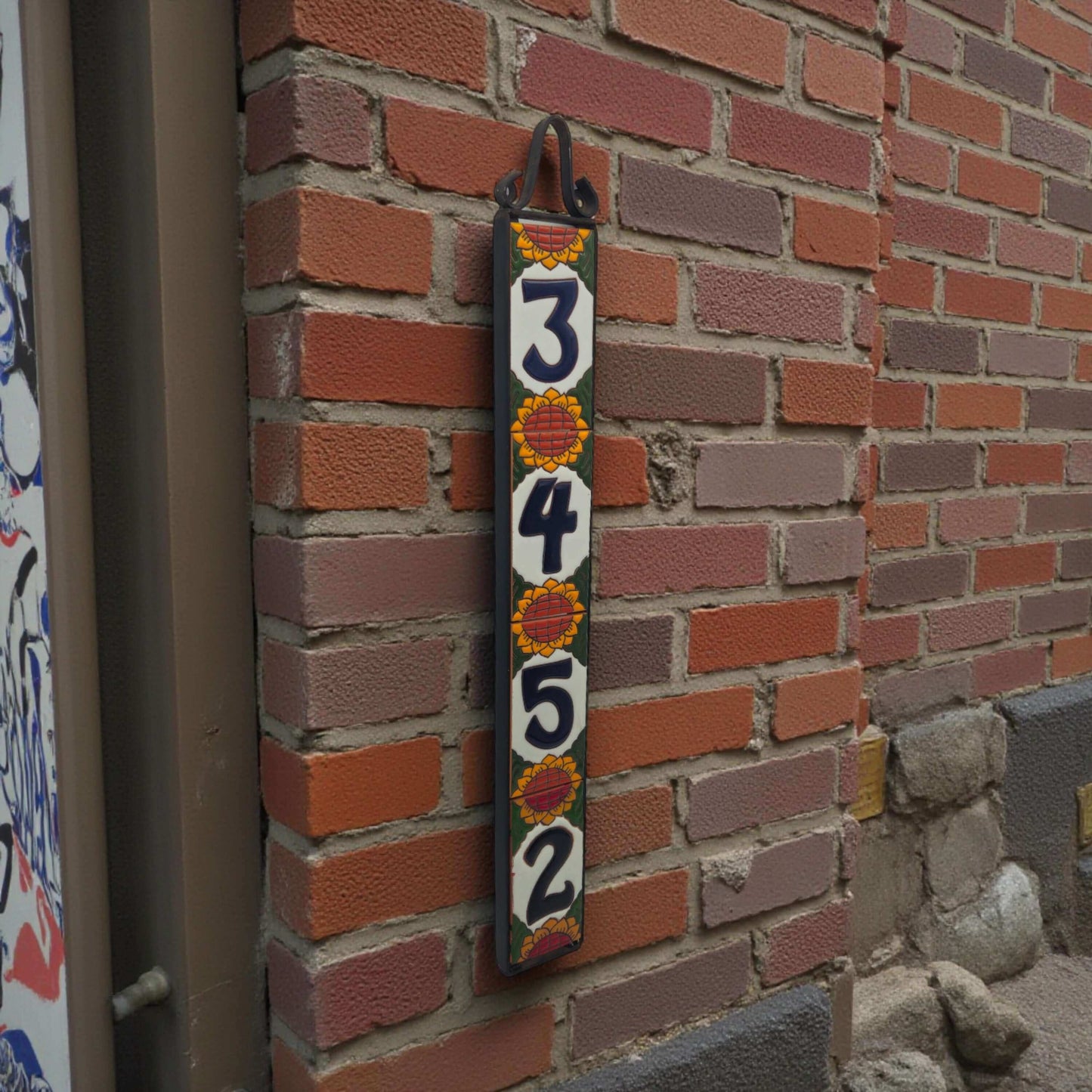 Sunflower Talavera Number Tiles | Mexican Address Art vertical hand-painted sunflower address plaque showing 3-4-5-2 on brick wall