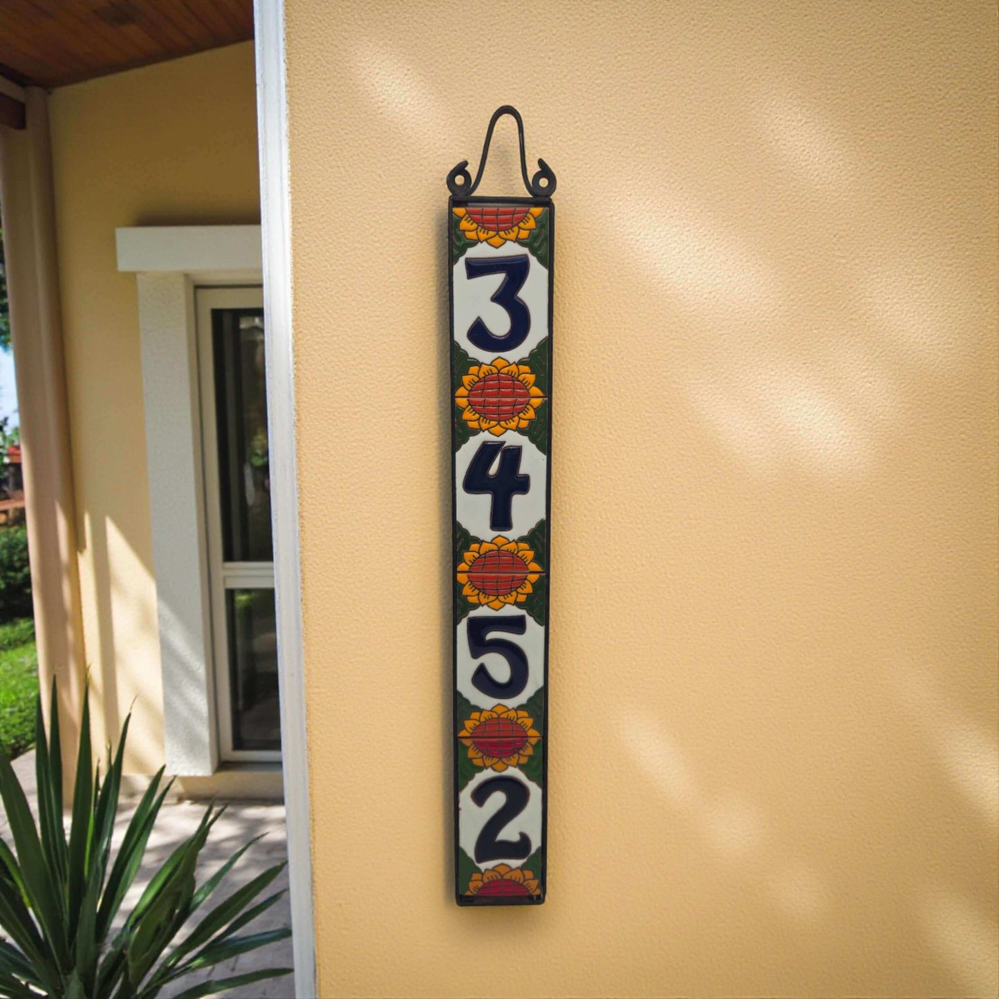 Sunflower Talavera Number Tiles | Mexican Address Art vertical hand-painted sunflower number tile set hanging on warm stucco wall
