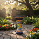 The Talavera Hub Talavera bird bath with blue rim and vibrant, hand-painted Mexican folk art patterns in assorted colors. Ceramic garden decor.