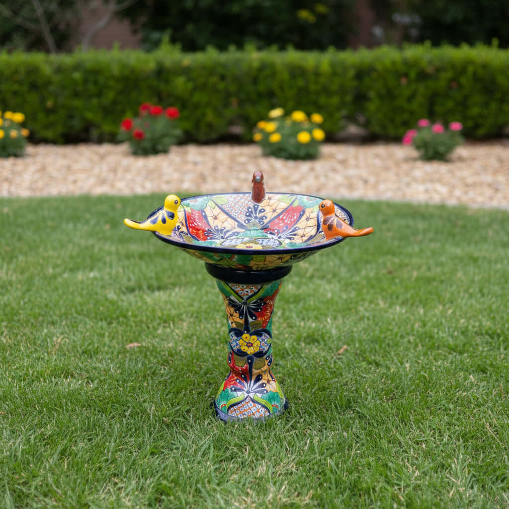 Talavera Bird Bath with Blue Rim | Colorful Mexican Garden Decor hand-painted bird bath with three colorful ceramic birds on green lawn