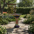 The Talavera Hub Talavera bird bath with blue rim and colorful hand-painted Mexican folk art patterns. Ceramic garden decor.